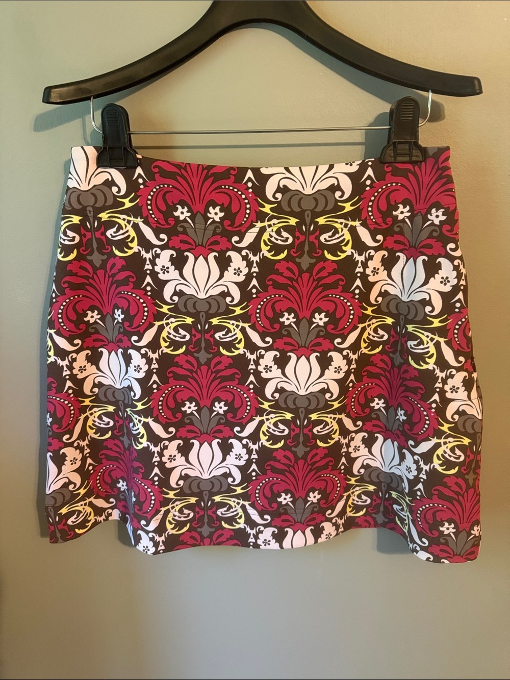 Athleta mini skirt with shorts. Brown/Pink floral pattern. Size medium